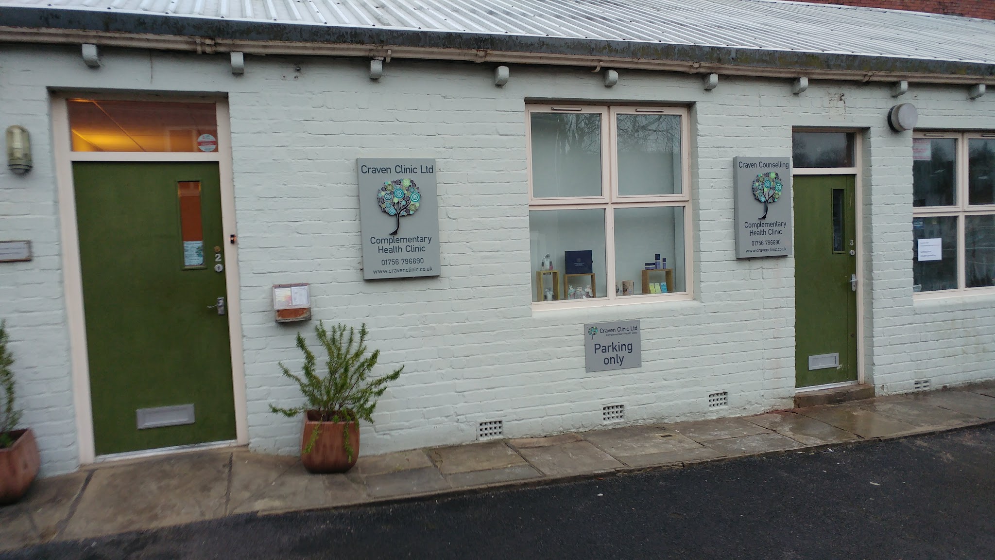 The Craven Clinic door and circle-tree sign in the Mount Pleasant courtyard