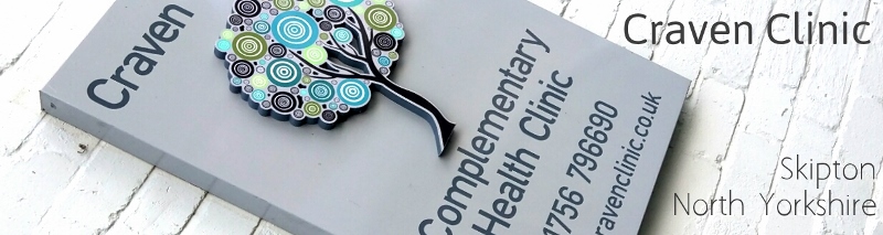 The Craven Clinic circle-tree sign on the courtyard wall
